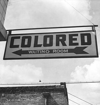 Sign for "colored" waiting room at a...