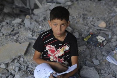 Rayan*, 13, in the rubble of his former school in the Gaza Strip. (* indicates that the name has been changed to protect identity. This must be reflected in all usage). Photo by Anas Baba/Save the Children. (PRNewsFoto/Save the Children)
