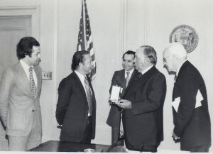 The Ambassador of Morocco (2nd from left) greets Chicago Mayor Richard J. Daley (2nd from right) at his City Hall office to receive a commemoration honoring the special relationship between America and Morocco. Picture center is Baker Lemseffer who was the director of the CHicago office of the Morocco Cultural Center. On the right is Col. Jack Reilly and on the left is a Moroccan  aid who accompanied the Ambassador. The story was the mainstory in a 1976 issue of The Middle Eastern Voice Newspaper published by Ray Hanania in Chicagoland.