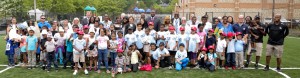 American children in New Jersey lineup on new soccer field donated by UAE.
