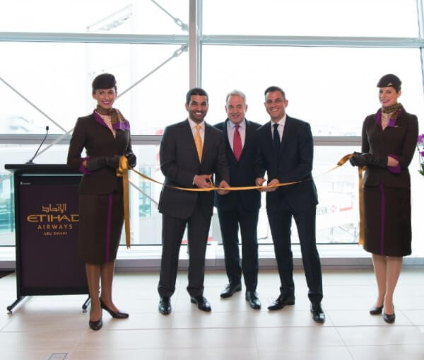 Etihad Airways President and Chief Executive Officer James Hogan is joined in a ribbon-cutting ceremony inaugurating the airline&apos;s new premium First and Business Class Lounge at New York&apos;s John F. Kennedy International Airport by Hareb Almuhairy, Senior Vice President, Corporate and International Affairs (L), Martin Drew, Senior Vice President, The Americas (R) and Etihad Airways&apos; cabin crew. (PRNewsFoto/Etihad Airways)
