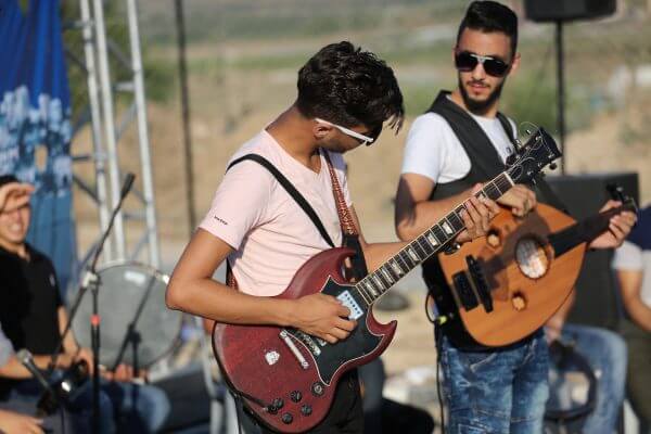 Palestinian band Dawaween, who were denied access to perform at a festival in Jerusalem, deliver a performance as part of a protest against the denial in Beit Hanun, near the Erez crossing point with Israel, in the northern Gaza Strip on August 6, 2016. Photo by Mohammed Asad