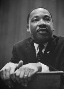 Martin Luther King leaning on a lectern. (Photo credit: Wikipedia)