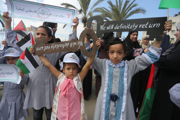 Palestinian children remind the world that they will not surrender their rights as Israel blocks the implementation of peace and continues the oppression of Palestinians and land confiscation in Palestine outside the UN School in Beit Lahia, Gaza Strip where UN Secretary General Antonio Guterres spoke during his visit to the Gaza Strip on August 30, 2019. Guterres visited Palestine August 29 and 30, 2017. Photo courtesy of Mohammed Asad.
