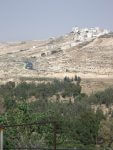 Partial view of the hilltop Palestinian village of Hisma (Hizma), with northbound Jerusalem highway and Mir Forest in the foreground. (Photo credit: Wikipedia)