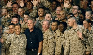 U.S. Service members gather around President George W. Bush during a visit to Al Asad Air Base, Iraq. Bush was joined by Secretary of Defense Robert M. Gates, Secretary of State Condolezza Rice, Chairman of the Joint Chiefs of Staff Gen. Peter Pace, U.S. Central Command Commander Adm. William J. Fallon, Commander of Multinational Forces-Iraq Gen. David Petreaus, Commander of Multinational Corps-Iraq Lt. Gen. Ray Odierno, and others. Defense Dept. photo by Cherie A. Thurlby (Photo credit: Wikipedia)