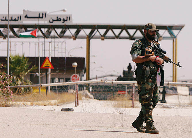 A Syrian soldier at the Nasib border crossing with Jordan in Deraa, Syria on July 7, 2018. At least 70 journalists and media workers are caught in Quneitra between advancing forces aligned with Syrian President Bashar al-Assad and the closed borders of Israel and Jordan, according to CPJ research. (Reuters/ Omar Sanadiki) Photo courtesy of the Committee to Protect Journalists