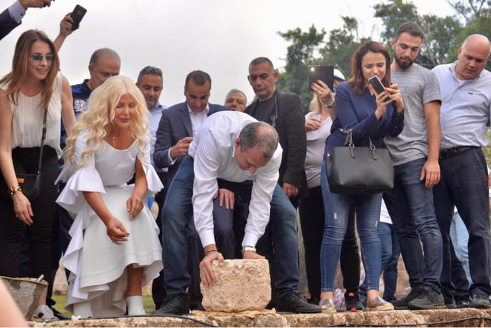 Michigan Accident Attorney Joumana Kayrouz helps place the corner stone for the new Youth Hub Center she is funding in Batroun, Lebanon with Gebran Bassil, Minister of Foreign Affairs and Emigrants. Photo courtesy of Joumana Kayrouz