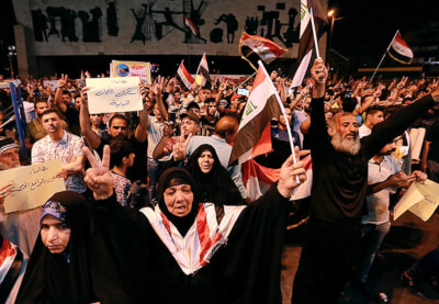 Iraqi protesters chant slogans during a demonstration in Tahrir Square in central Baghdad, Iraq, on June 21, 2019. Iraq suspended U.S.-funded broadcaster Al-Hurrah for 3 months over a corruption report on September 2. (AP Photo/Hadi Mizban) Photo courtesy of the Committee to Protect Journalists.